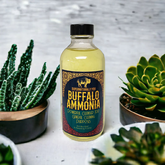 A bottle of Buffalo Ammonia floor wash placed on a surface with succulent plants in the background.